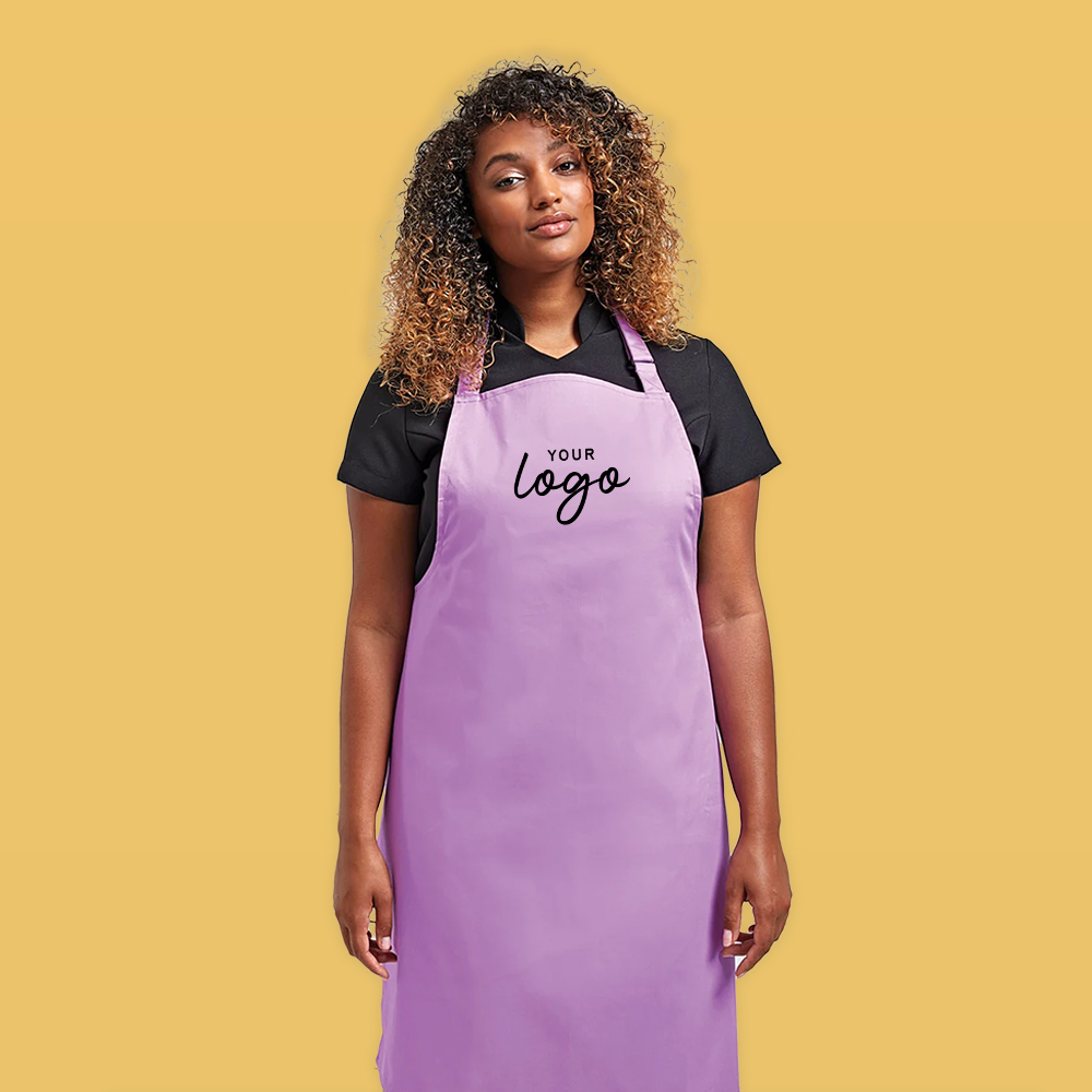 Young woman wearing a purple apron with the words 
